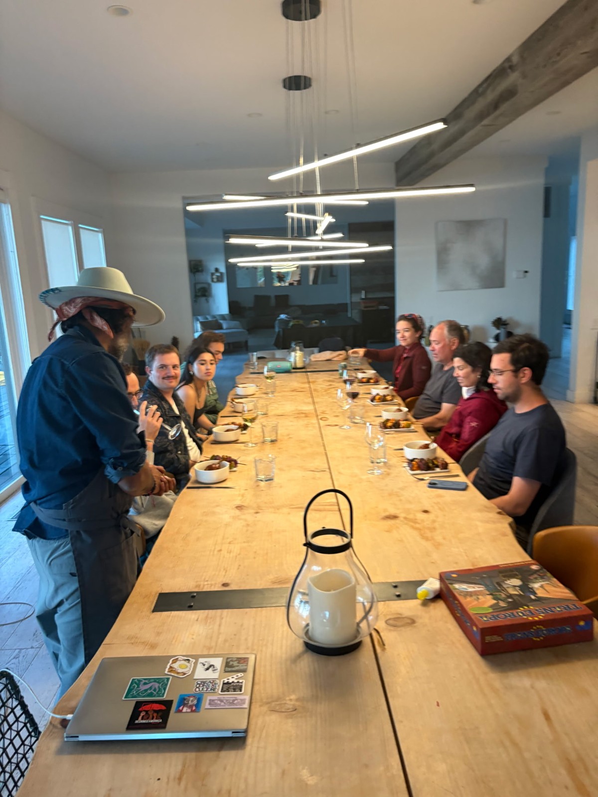 Ronish hosts guests around a long dining table at a private dinner