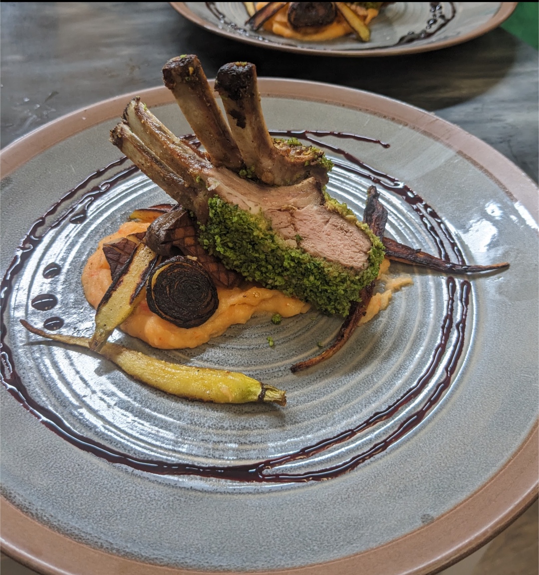 Herb-crusted rack of lamb with roasted vegetables and golden puree